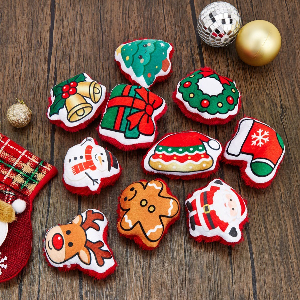 Nine Christmas-themed cat toys arranged on a wooden surface