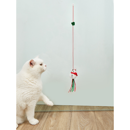 Cat reaching toward a hanging Snowman cat toy