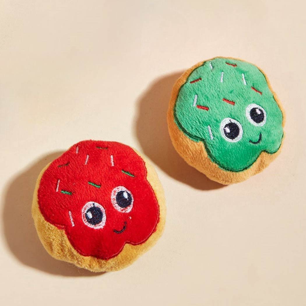 Red and green doughnut-shaped cat toys with embroidered faces