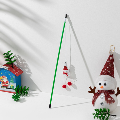 Green cat teaser wand with a snowman ornament and red pom-poms