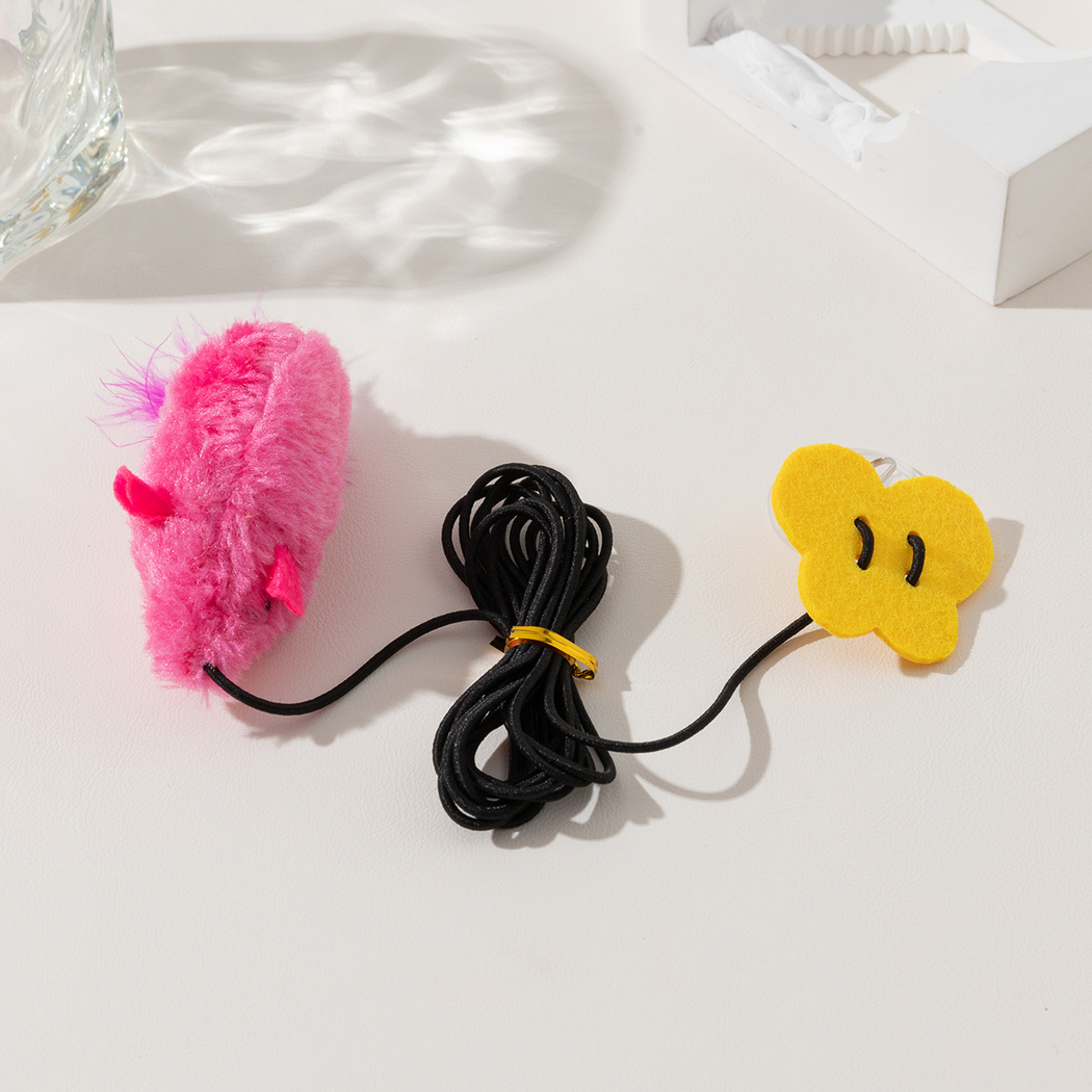 Close-up of the Pink mouse toy, cord, and flower-shaped suction-cup cover
