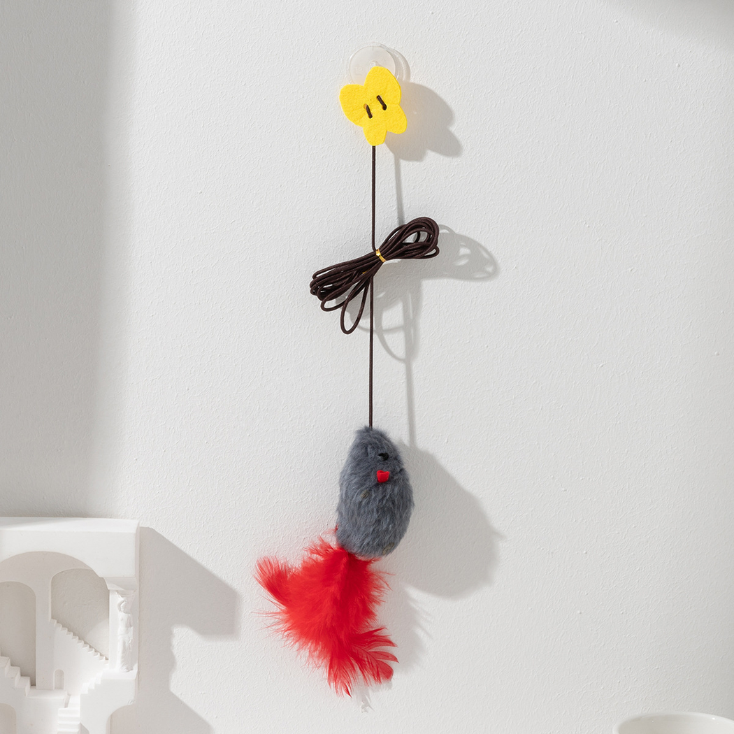 Gray hanging mouse cat toy mounted on a wall by its suction cup