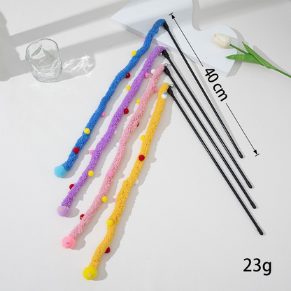 Four fuzzy cat teaser wands arranged beside a 40 cm measurement marker