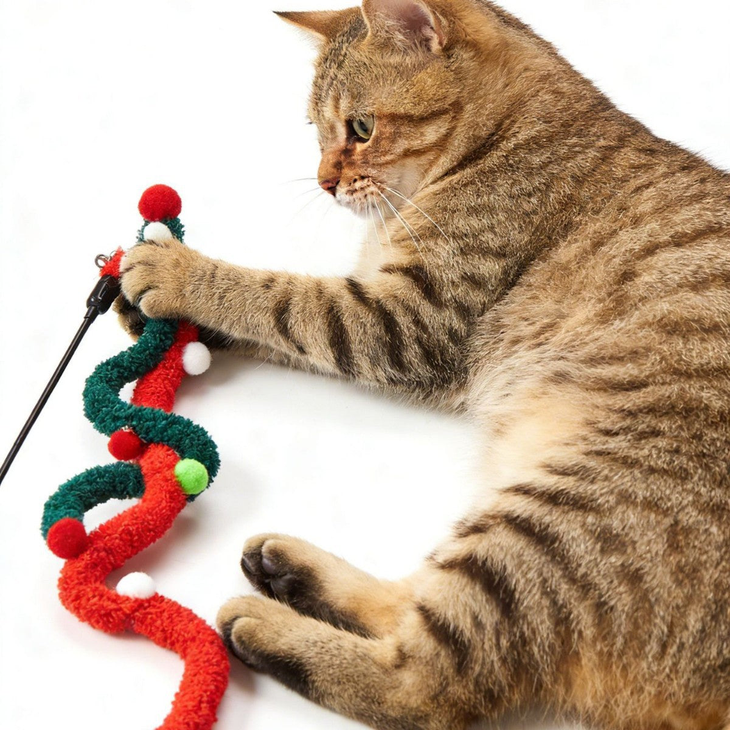 Cat pawing at intertwined red and dark green cat teaser attachments