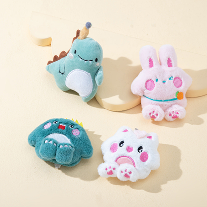 Four plush character cat toys arranged on a cream display