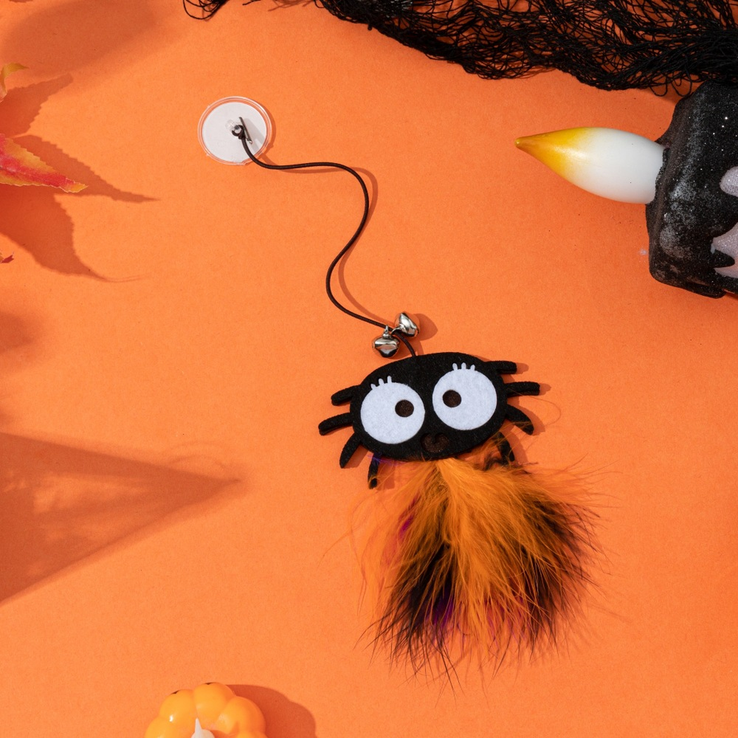 Large-eyed spider suction-cup dangling cat toy with bells and orange-and-black fluffy tassel