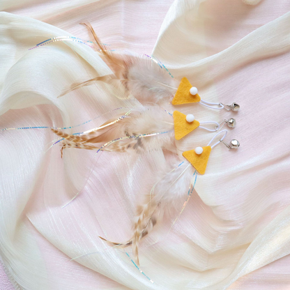 Three yellow fish-shaped cat teaser replacement attachments with feather tails and bells