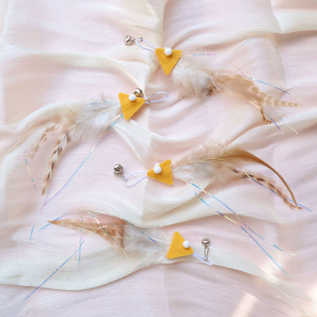 Four yellow fish-shaped cat teaser replacement attachments displayed together