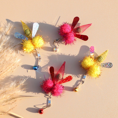 Yellow and fuchsia winged cat toy attachments with clips and bells