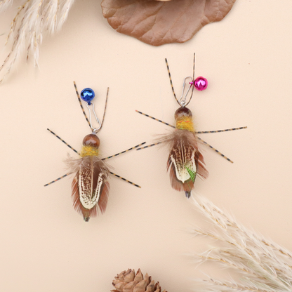 Two multicolor winged insect-shaped cat toys with blue and pink bells