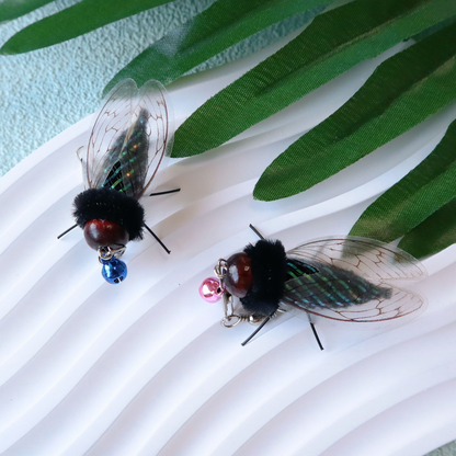 Two cicada-shaped cat toy attachments showing upright and side wing views