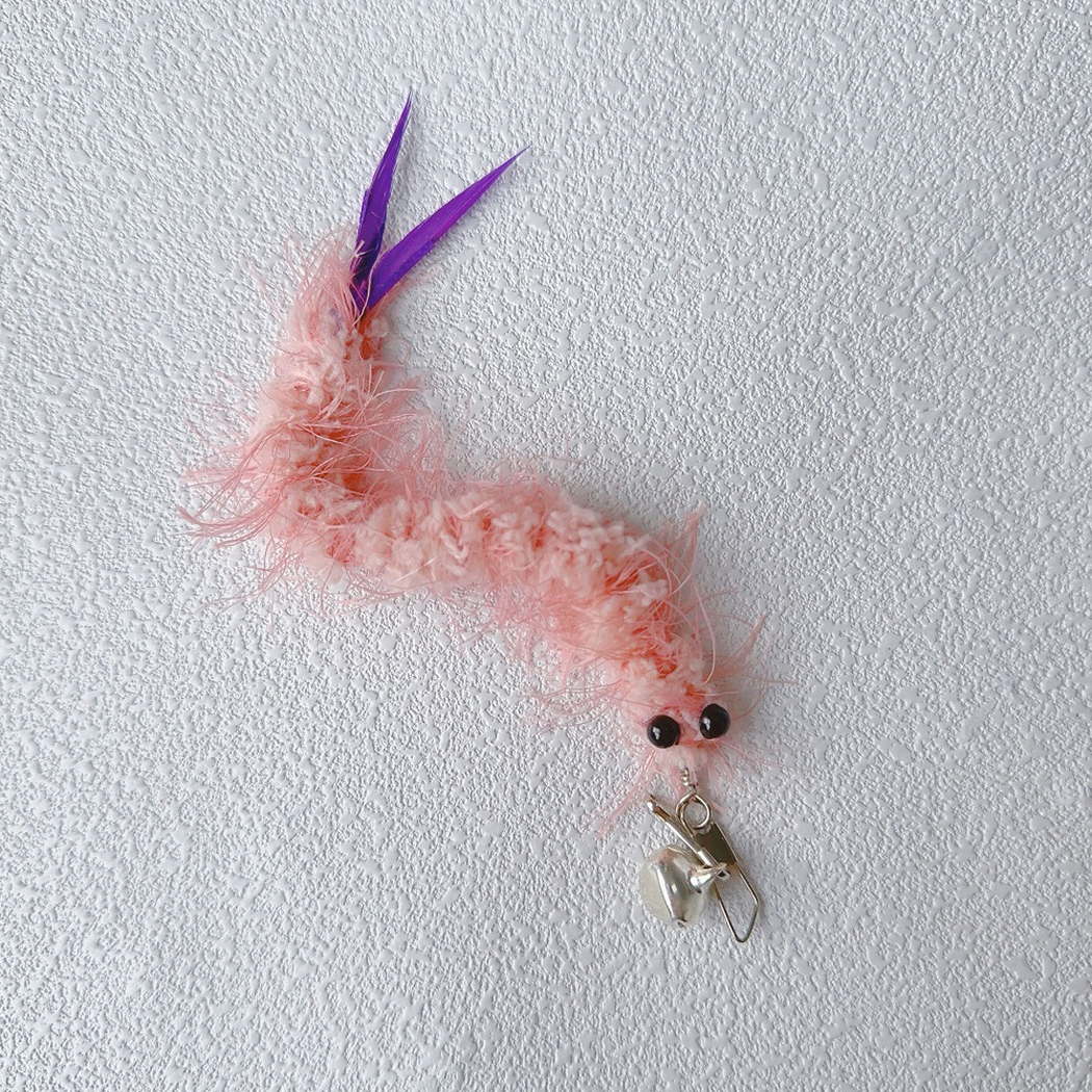 Pink fuzzy cat teaser replacement toy with purple tail feathers, clip, and bell