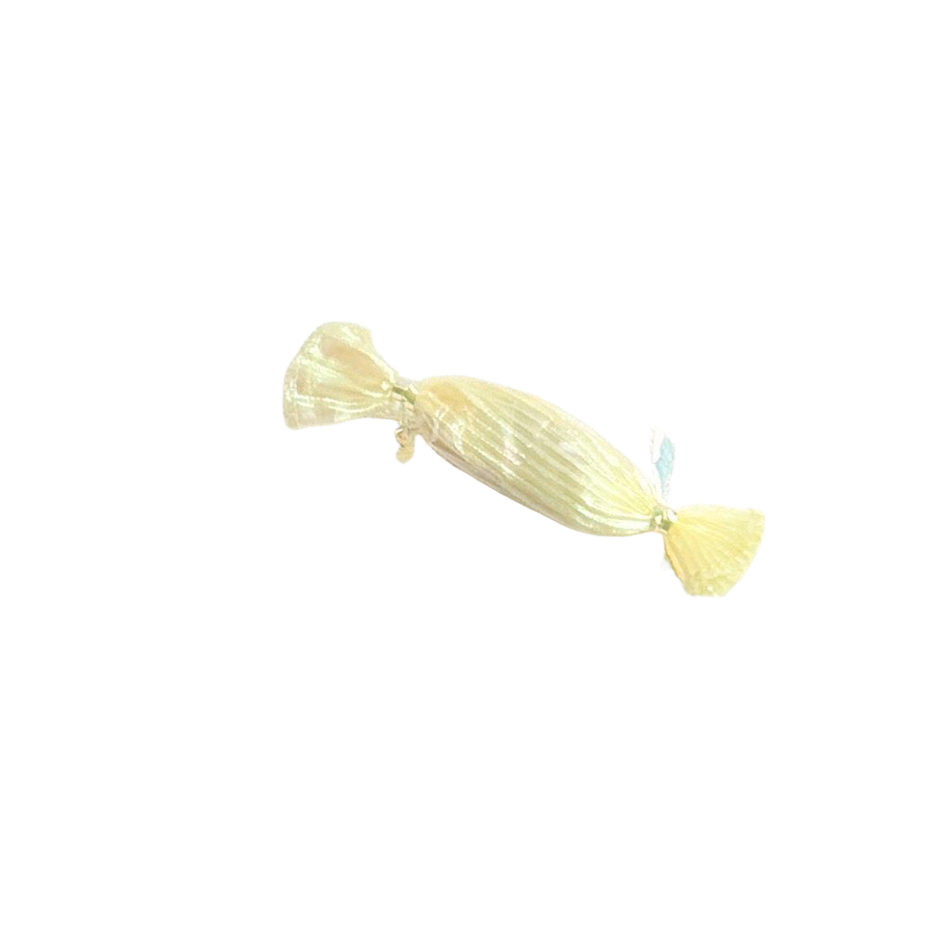 Yellow candy-shaped cat toy on a textured white background