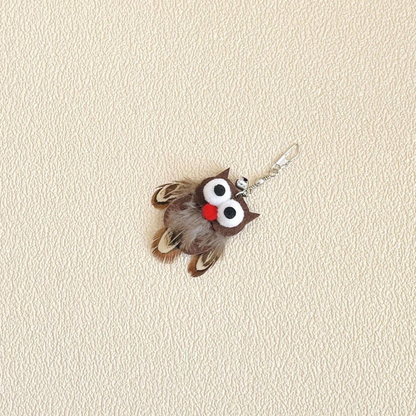 Owl-shaped cat toy attachment with oversized eyes, red beak, clip and bell