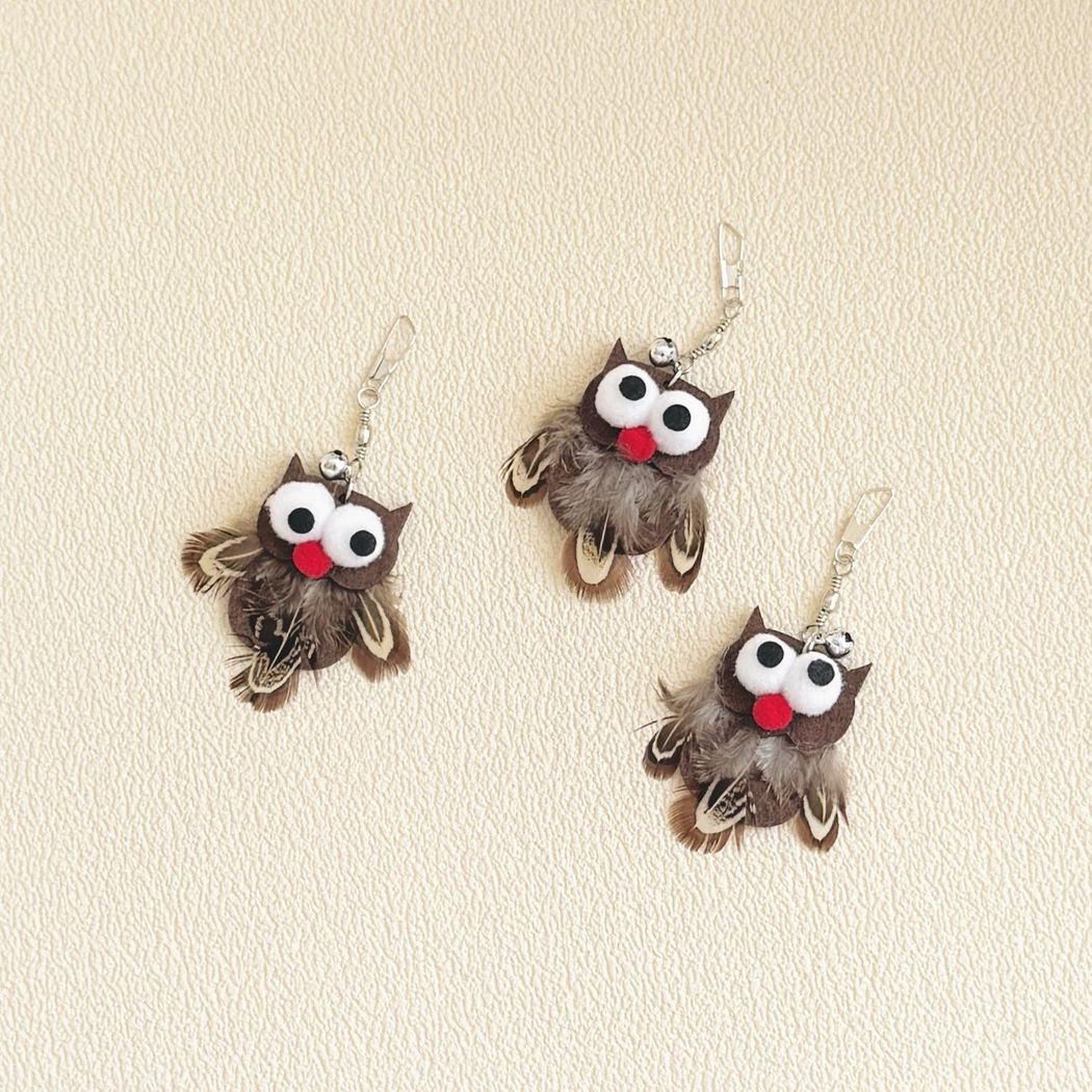 Three owl-shaped cat toy attachments displayed together
