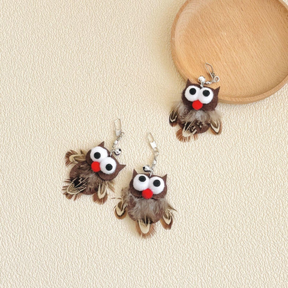 Three owl-shaped cat toy attachments arranged beside a round tray