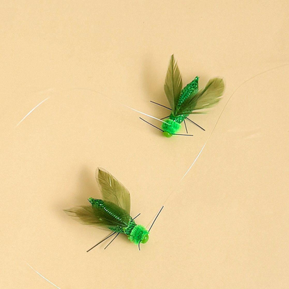 Two green winged insect-shaped cat toy attachments displayed together