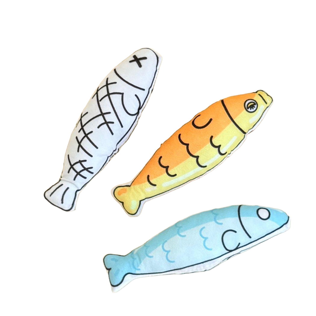 White, yellow and blue fish-shaped cat toys displayed together