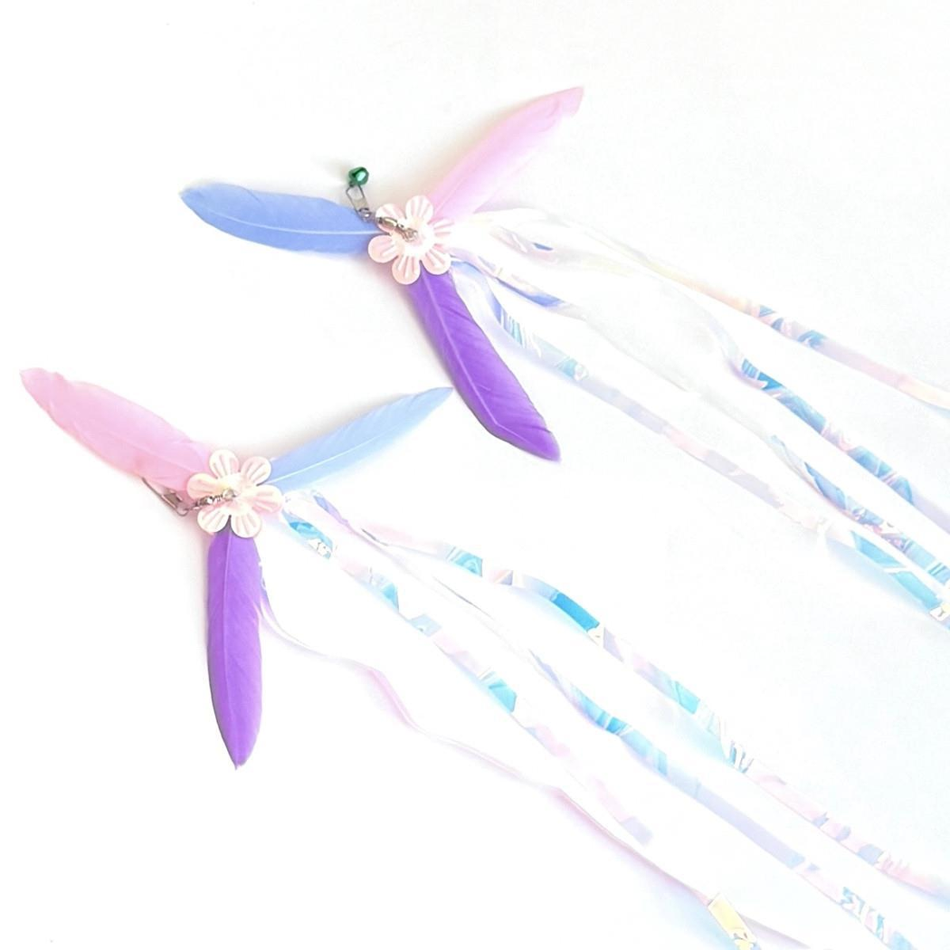 Two multicolor cat teaser attachments arranged diagonally with long iridescent streamers