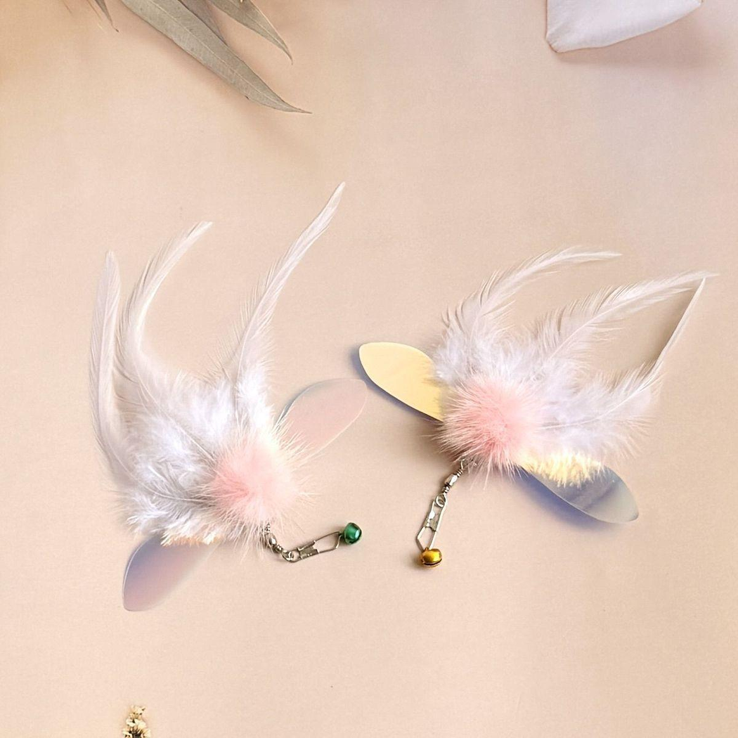 Two white feather cat toy attachments with different feather arrangements