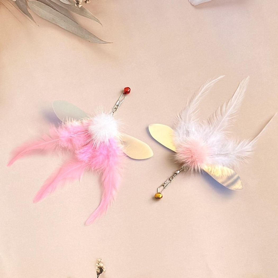 Pink and white feather cat toy attachments viewed from above