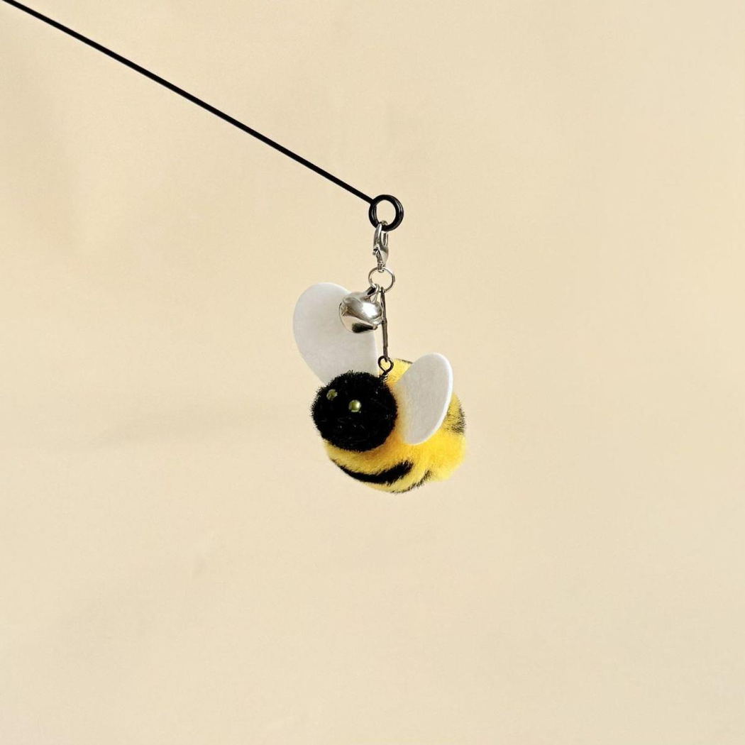 Yellow-and-black bee-shaped cat teaser wand attachment with white wings and bell