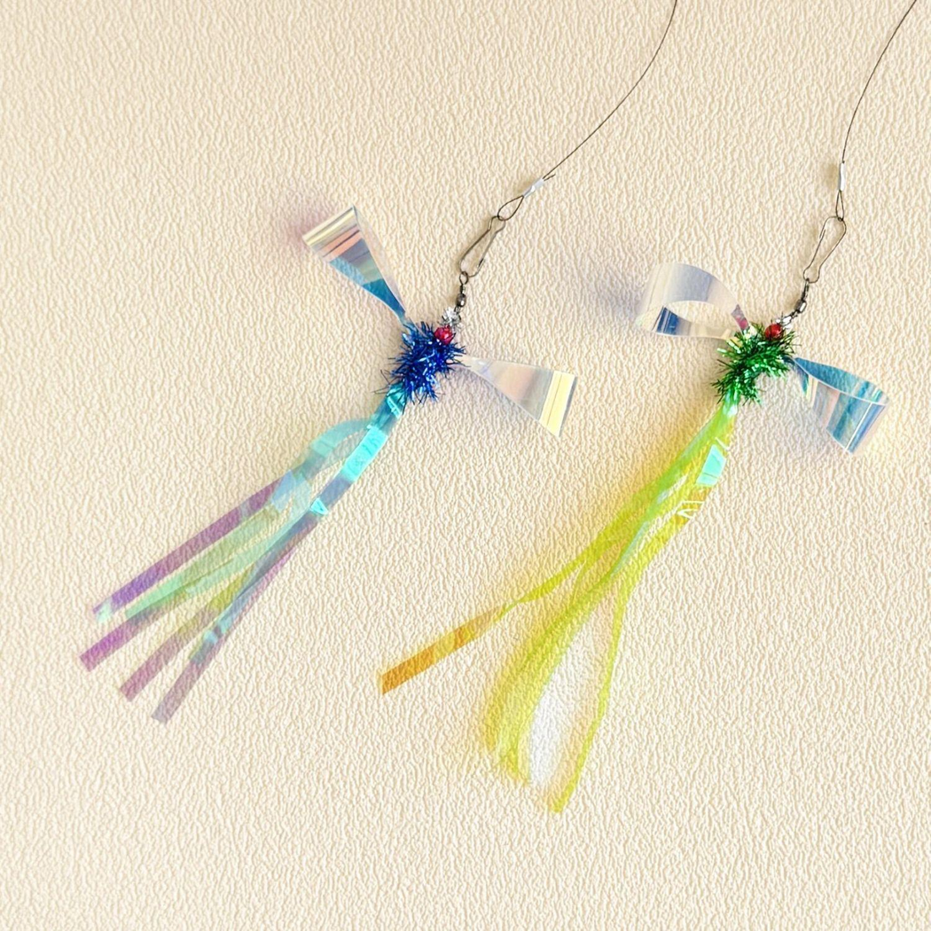 Two iridescent insect-shaped cat teaser lures displayed together