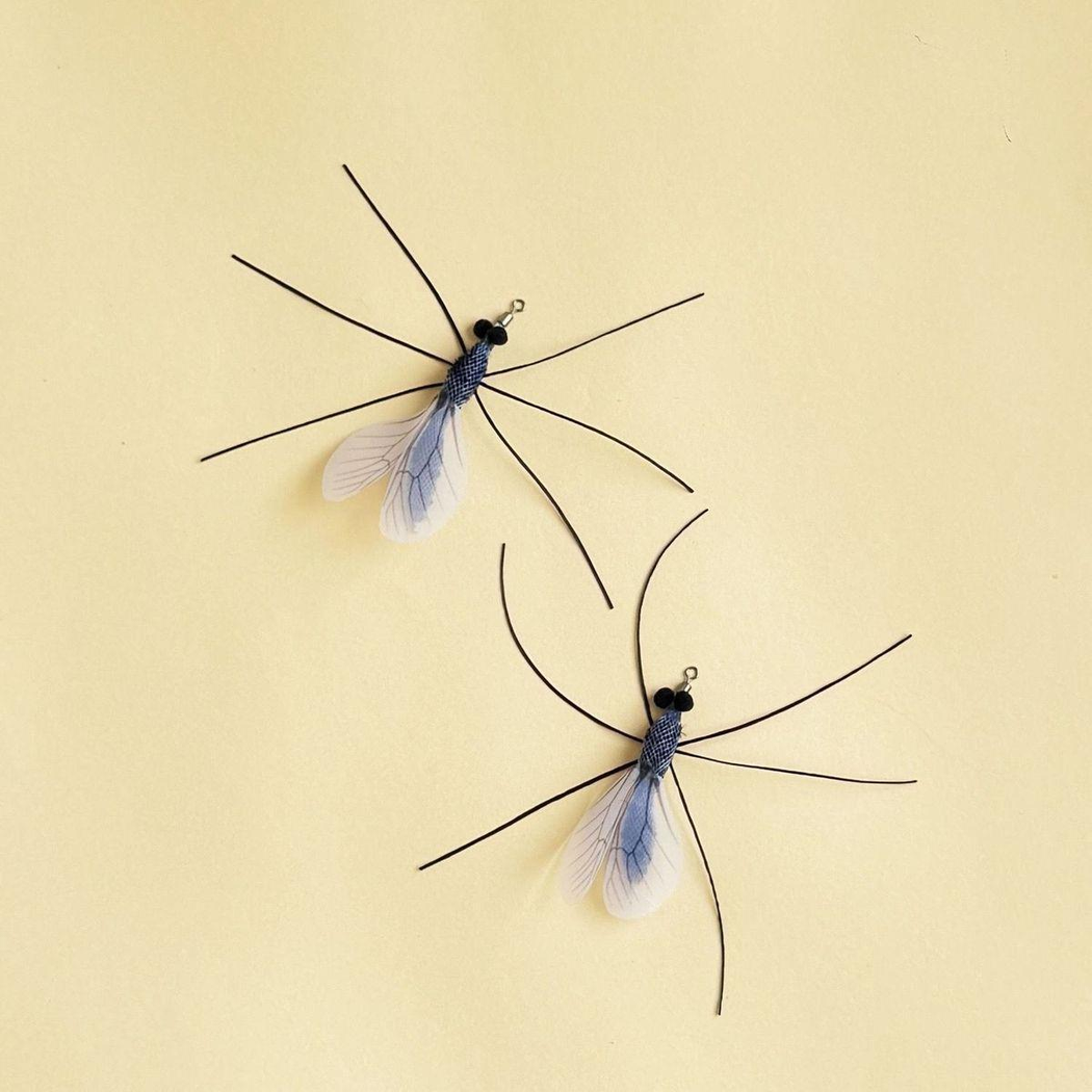 Two mosquito-shaped cat toy attachments displayed from opposite angles