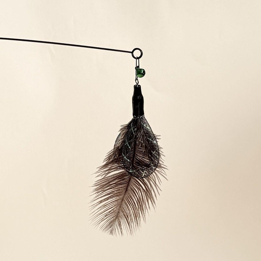 Dark feather cat wand attachment hanging from a wand