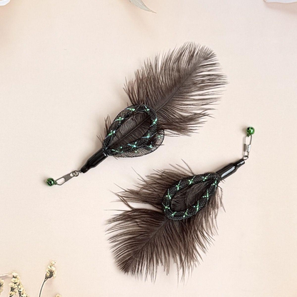 Two dark feather cat wand attachments arranged in opposite directions