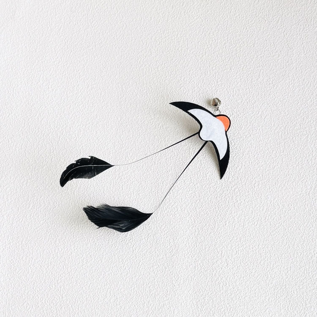 Swallow cat teaser attachment with bell and trailing black feathers