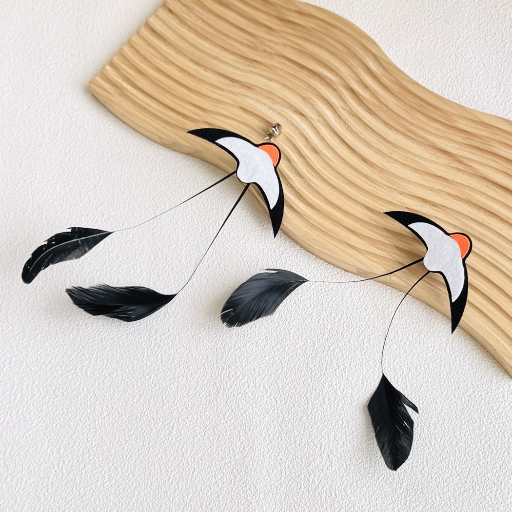 Close-up of Swallow attachments with bells and trailing black feathers