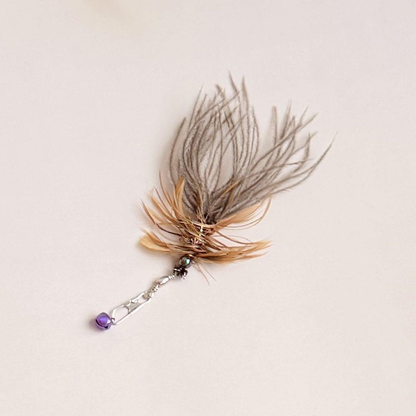 Feather teaser replacement attachment with a purple bell and silver-tone clasp