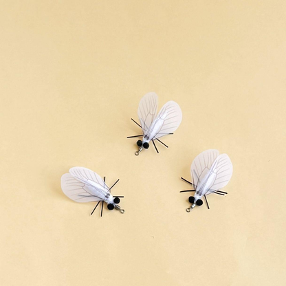 Three white moth-shaped cat toys displayed from different angles