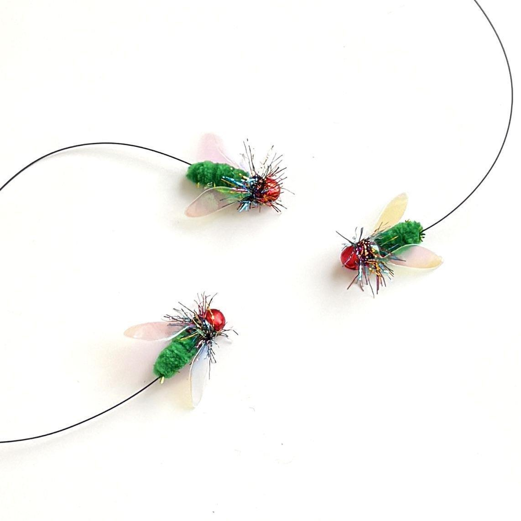 Three fly-shaped cat teaser replacement heads arranged on a white background