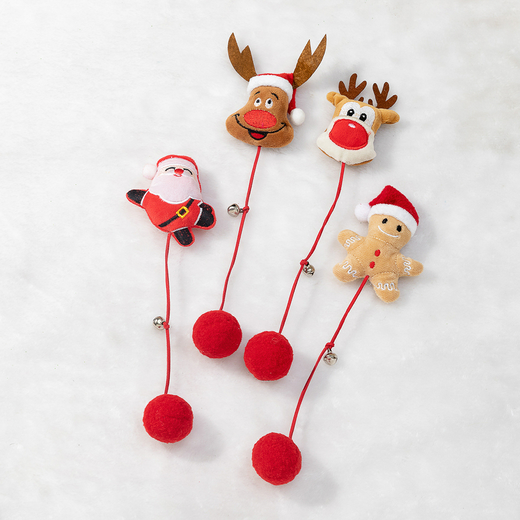 Four Christmas character cat toys with fuzzy pom-poms, red cords and bells
