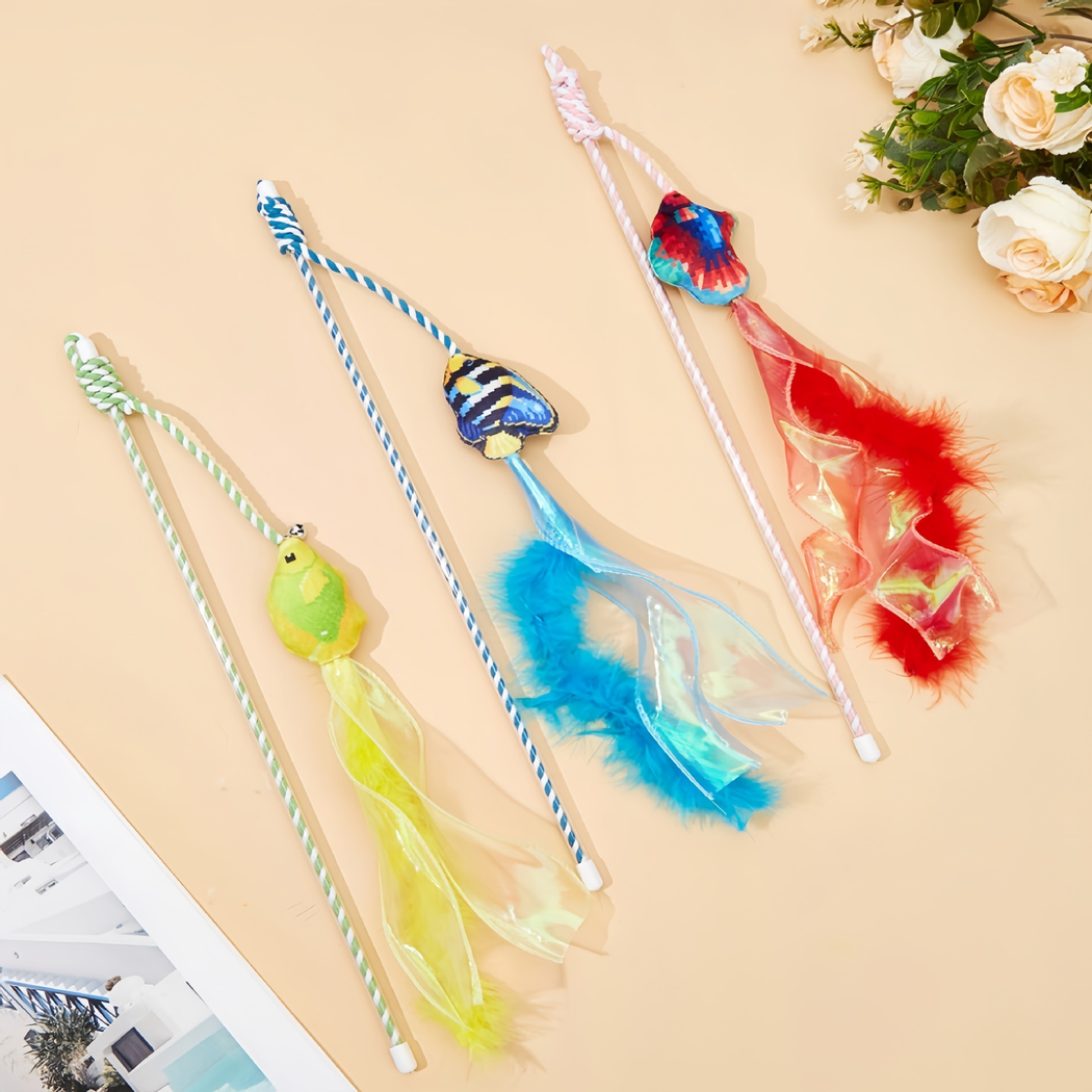 Red, blue and yellow fish wand cat toys laid flat with feather and ribbon streamers