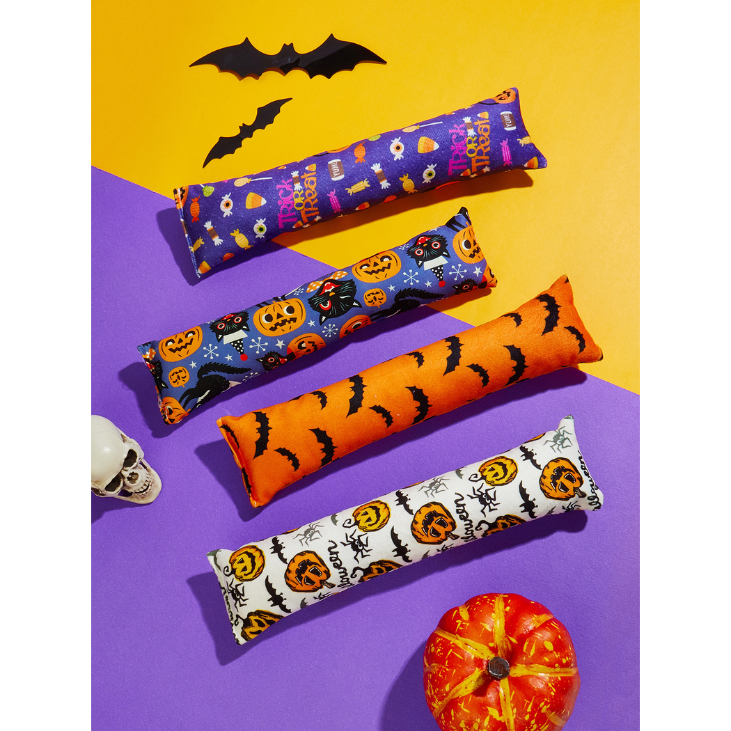 Four Halloween-pattern elongated cat toys arranged on purple and yellow backgrounds
