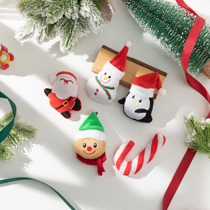 Five Christmas character cat toys arranged with festive greenery and ribbons