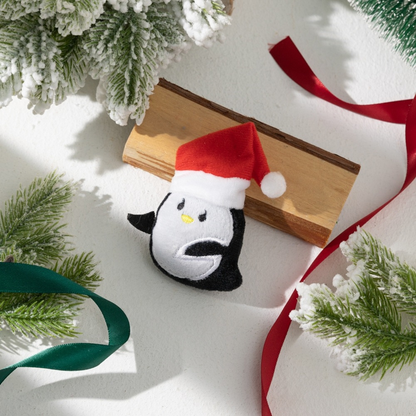 Penguin character cat toy wearing a red Santa hat
