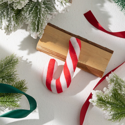Red and white candy cane-shaped cat toy