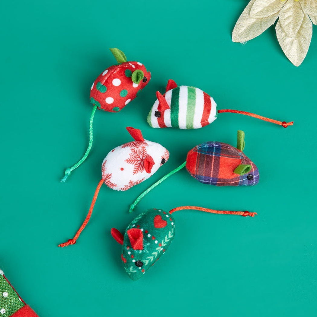 Five festive mouse-shaped cat toy styles arranged on a green background