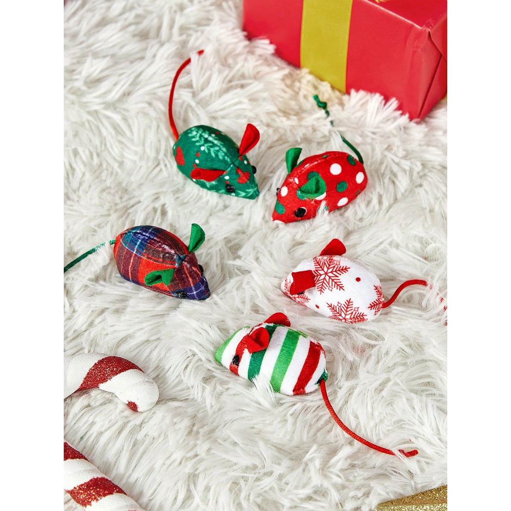 Five festive mouse-shaped cat toys arranged on a fluffy white surface