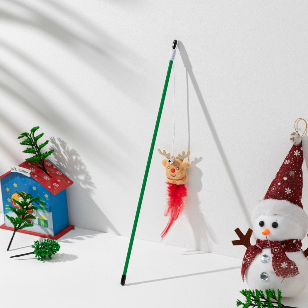 Reindeer character cat teaser wand with a red feather tail in a Christmas setting