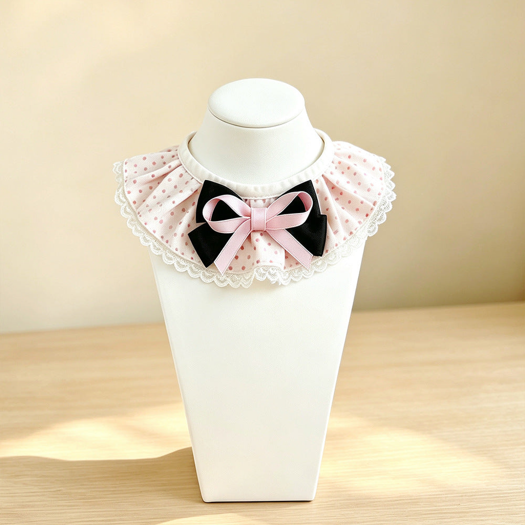 Light Pink polka-dot cat neckwear with layered bow on a display stand