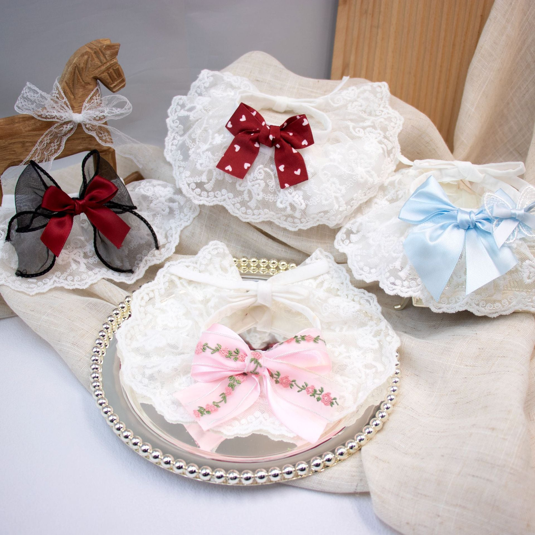 Four bow-accented lace-look cat neckwear styles displayed together