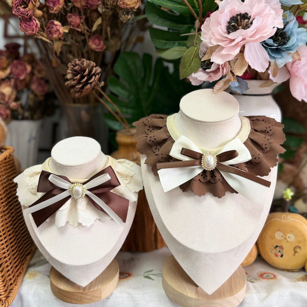 Brown and Ivory decorative pet neckwear displayed on stands