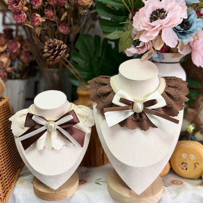 Brown and Ivory decorative pet neckwear displayed on stands