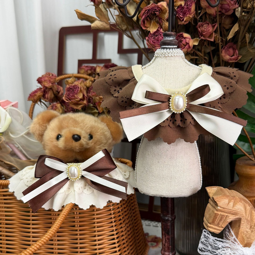 Brown and Ivory decorative pet neckwear arranged with a teddy bear and display stand