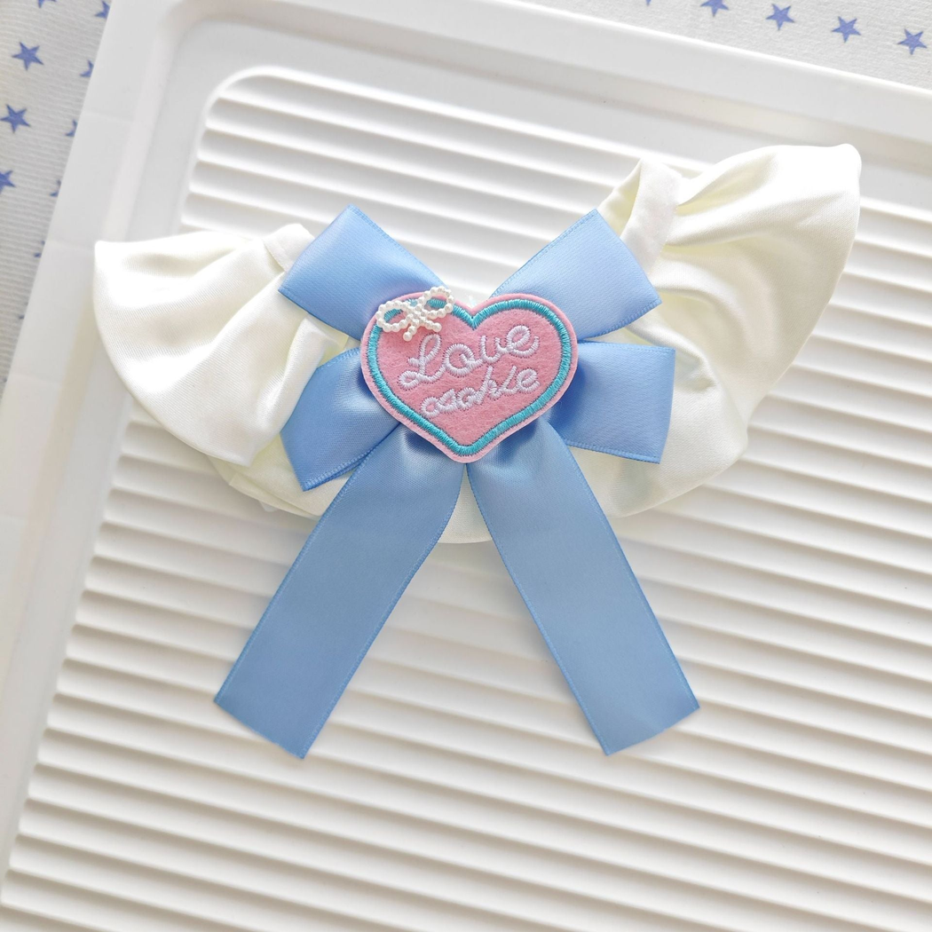 Light Blue ruffled pet neckwear with ribbon bow and pink heart accent